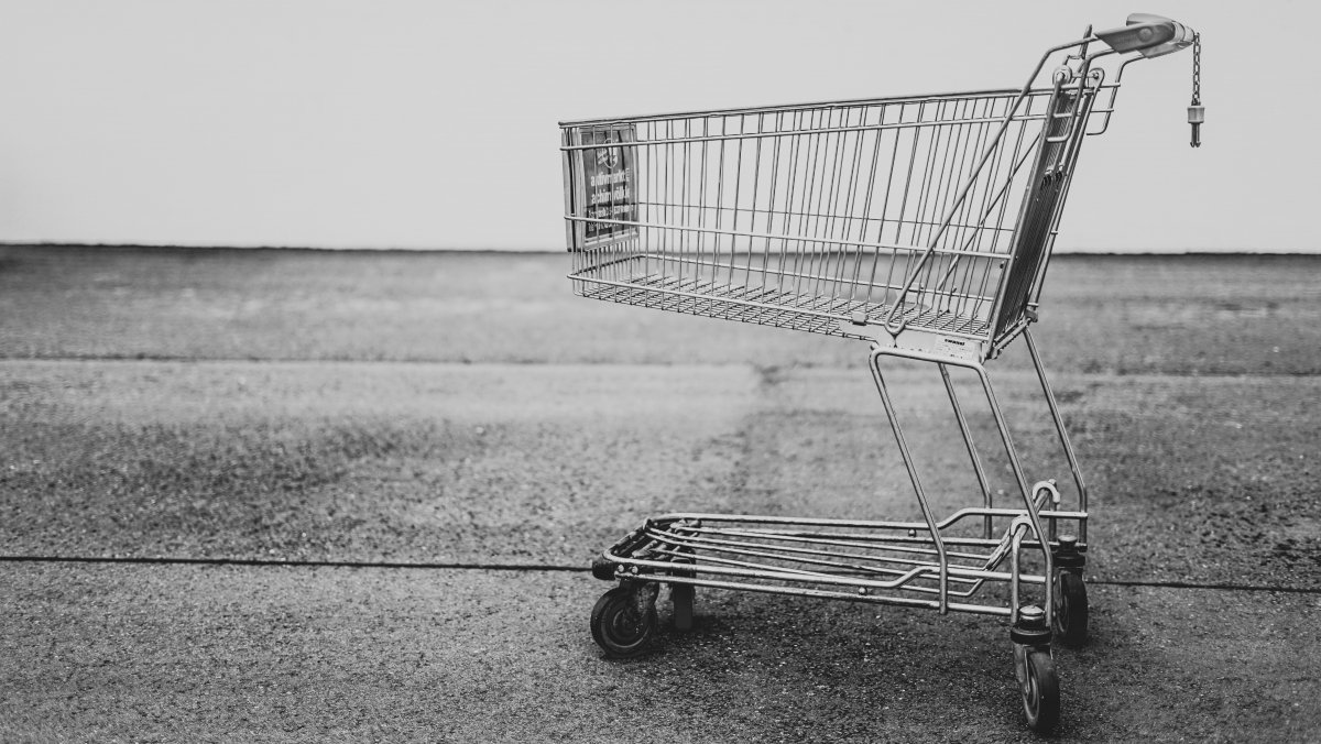 A black and white of a solitary shopping trolley.